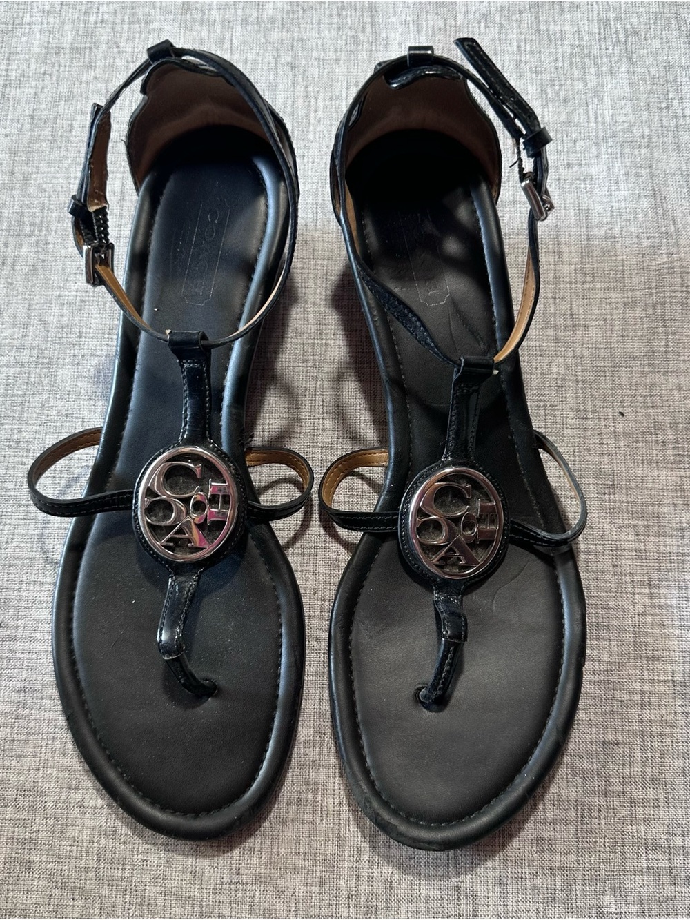 Coach Black Leather T-Strap Sandals with Silver Logo Medallion